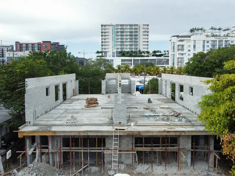Concrete shell rising in an urban block, aerial view