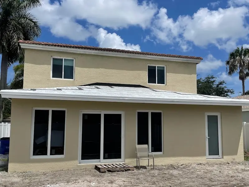Stucco home exterior with new openings