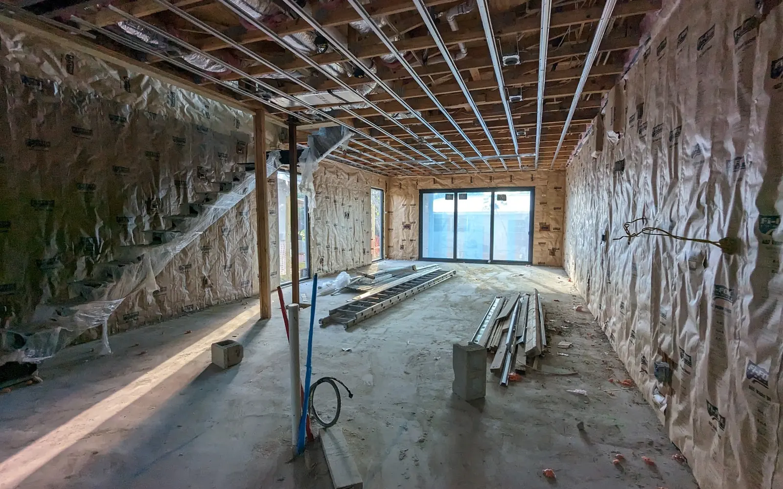 Open walls with fresh insulation after remediation