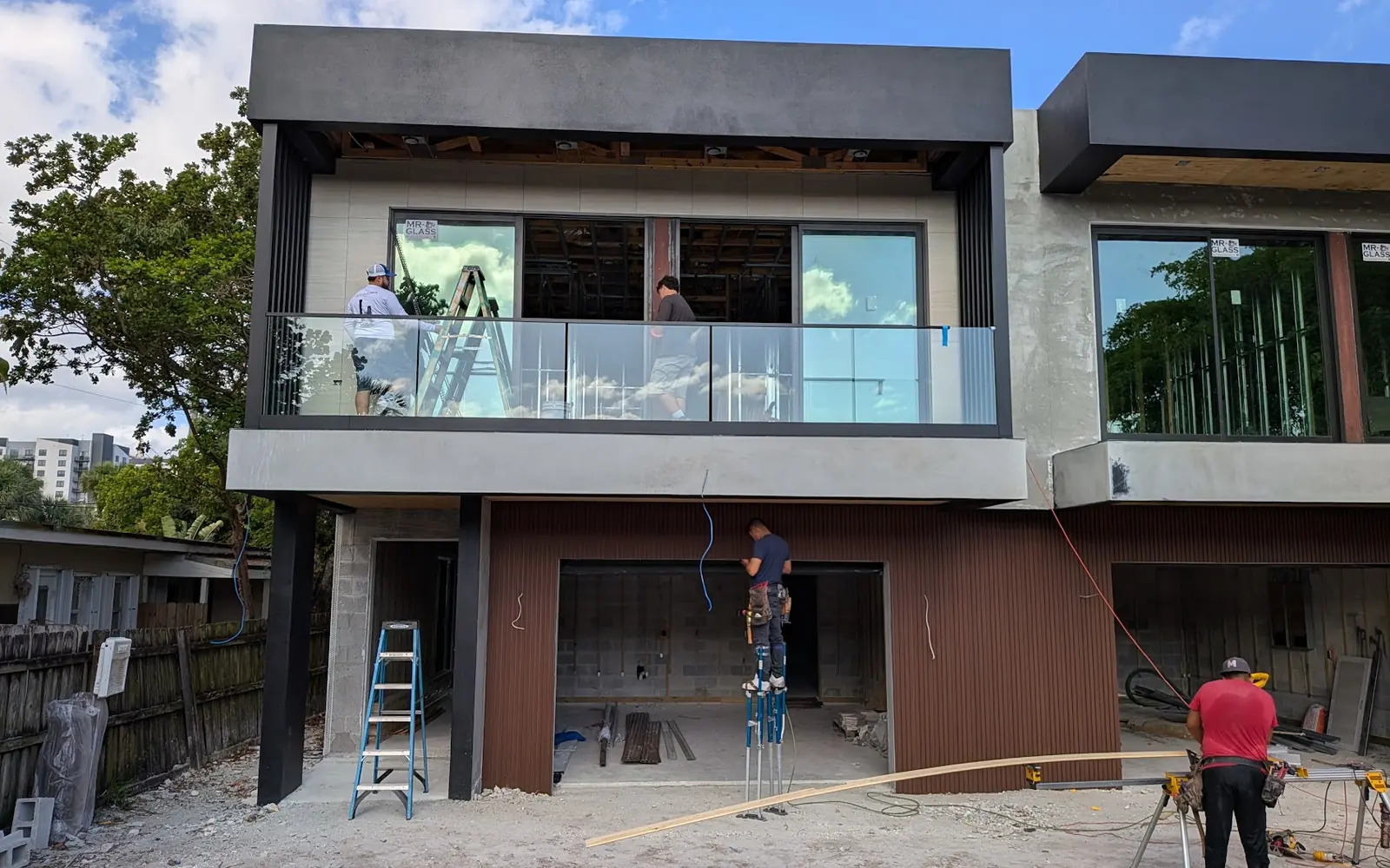 Multi-story building with balconies, exterior work in progress