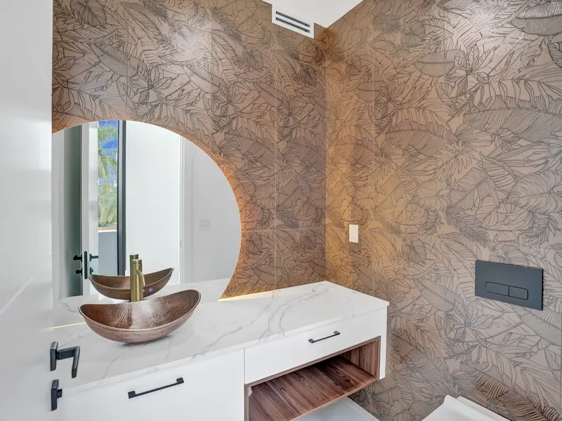 Powder room with stone counter and copper sink