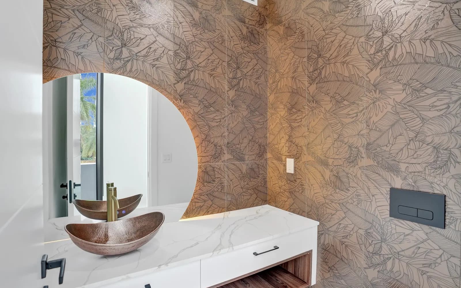 Designed powder room with feature wall and copper sink
