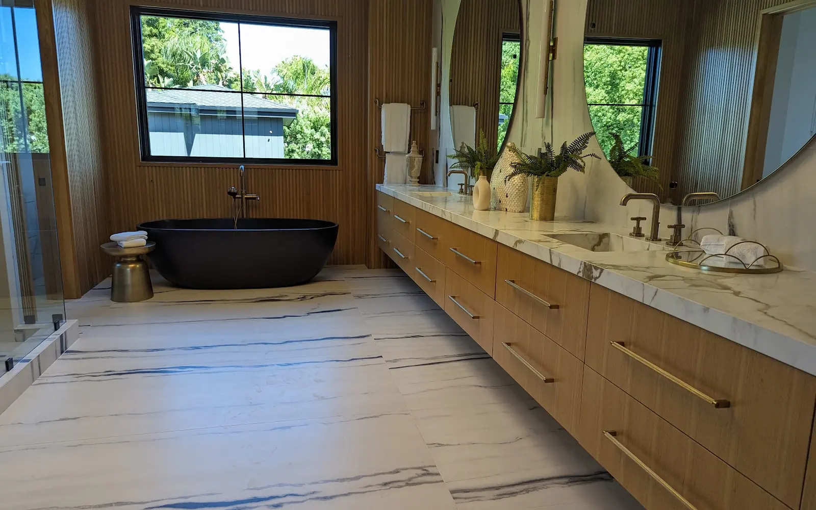 Finished master bathroom with double vanity and marble floor