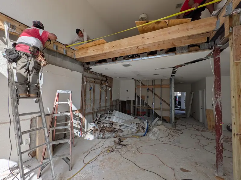 Crew working on ceiling framing