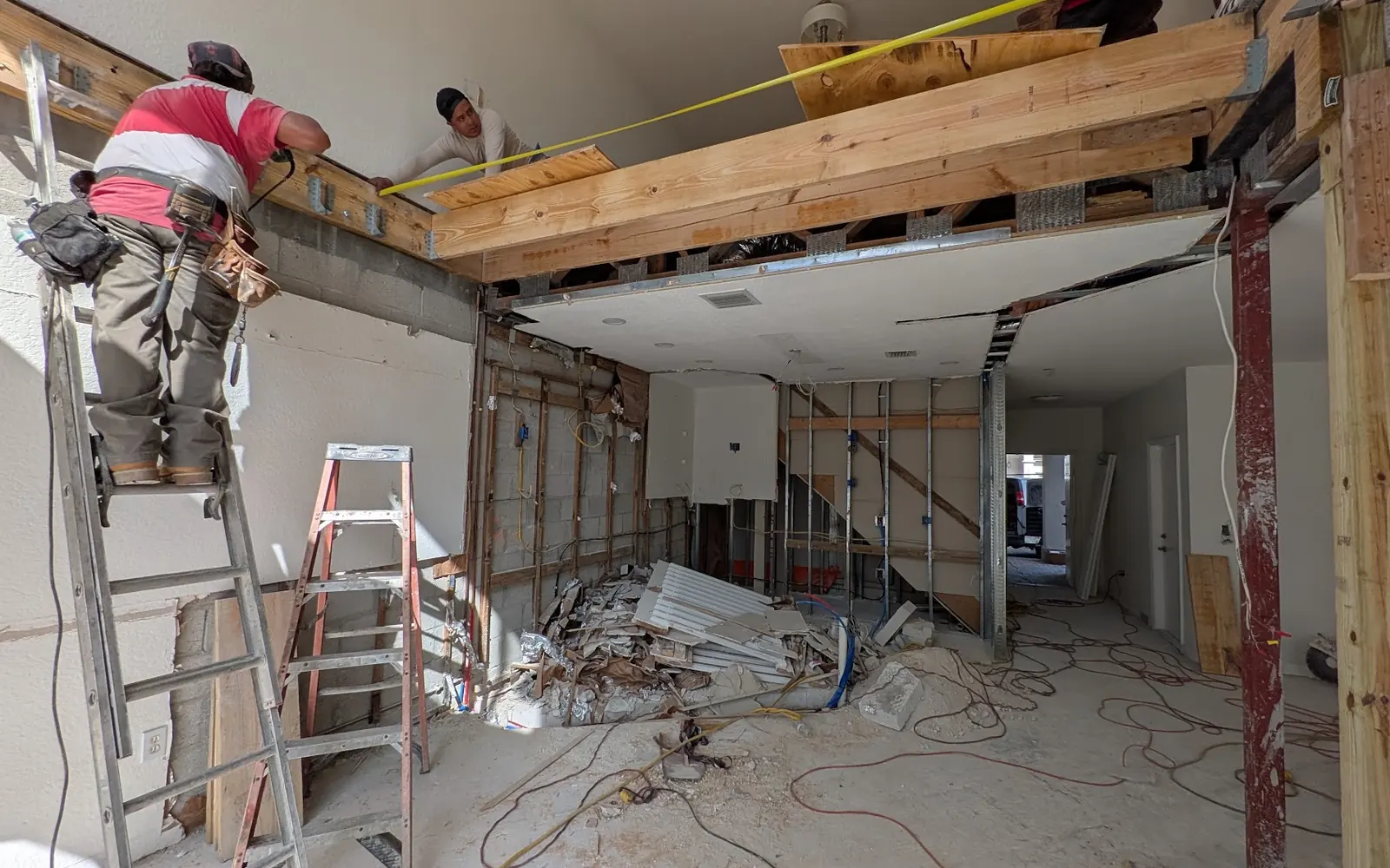 Crew working on ceiling framing and ductwork