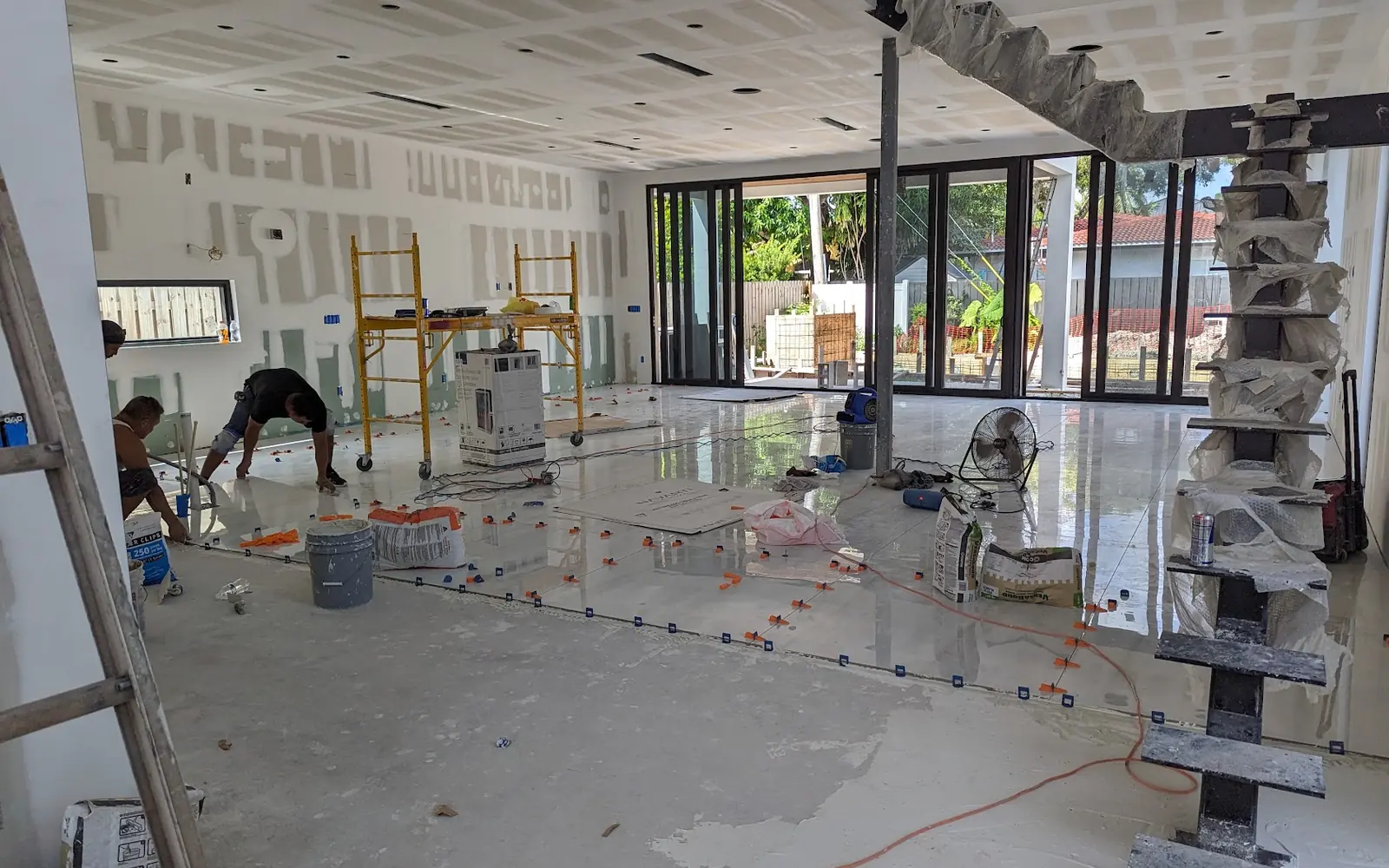 Large-format porcelain floor going in