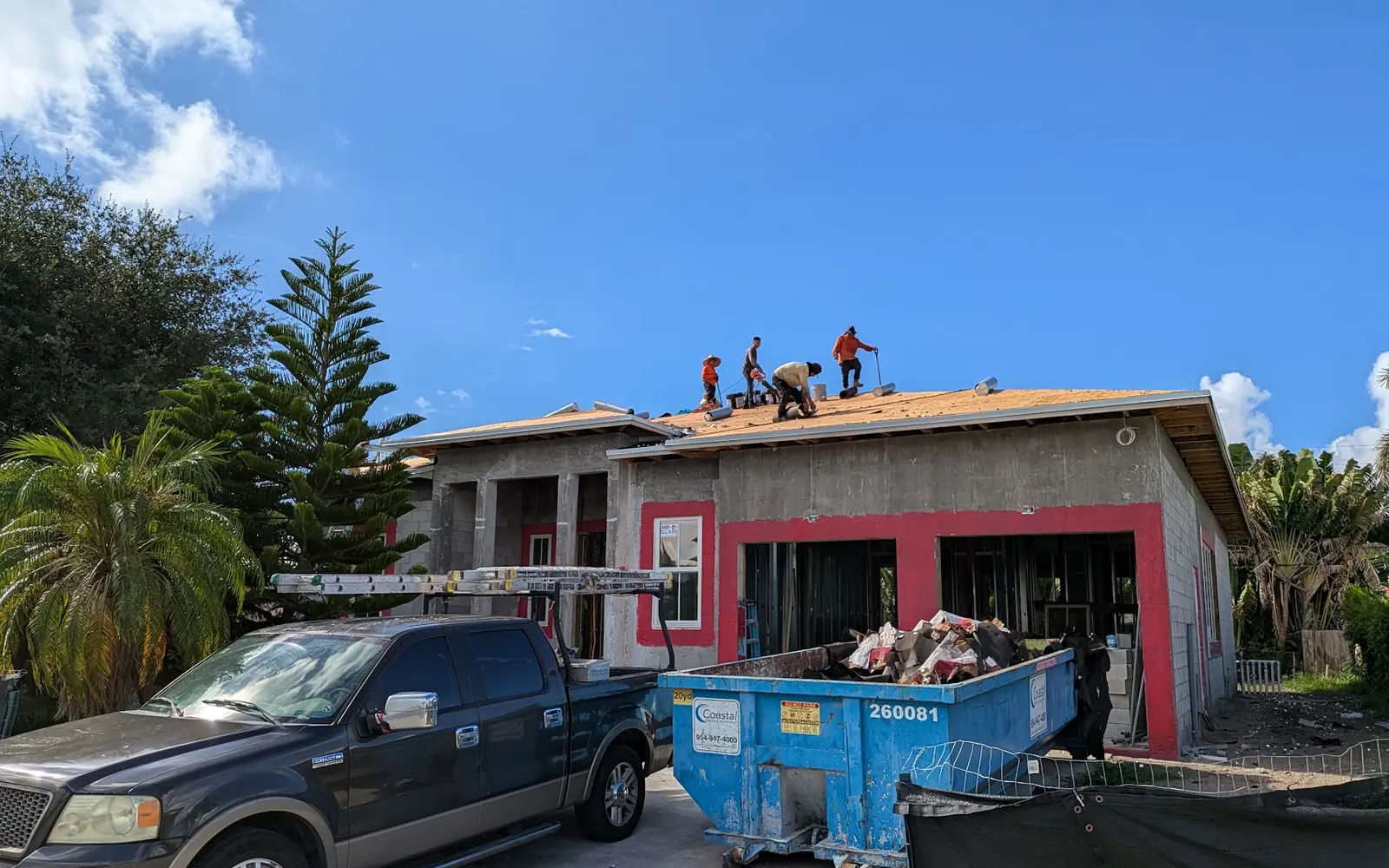 Stucco and roofing crew on a single-story home