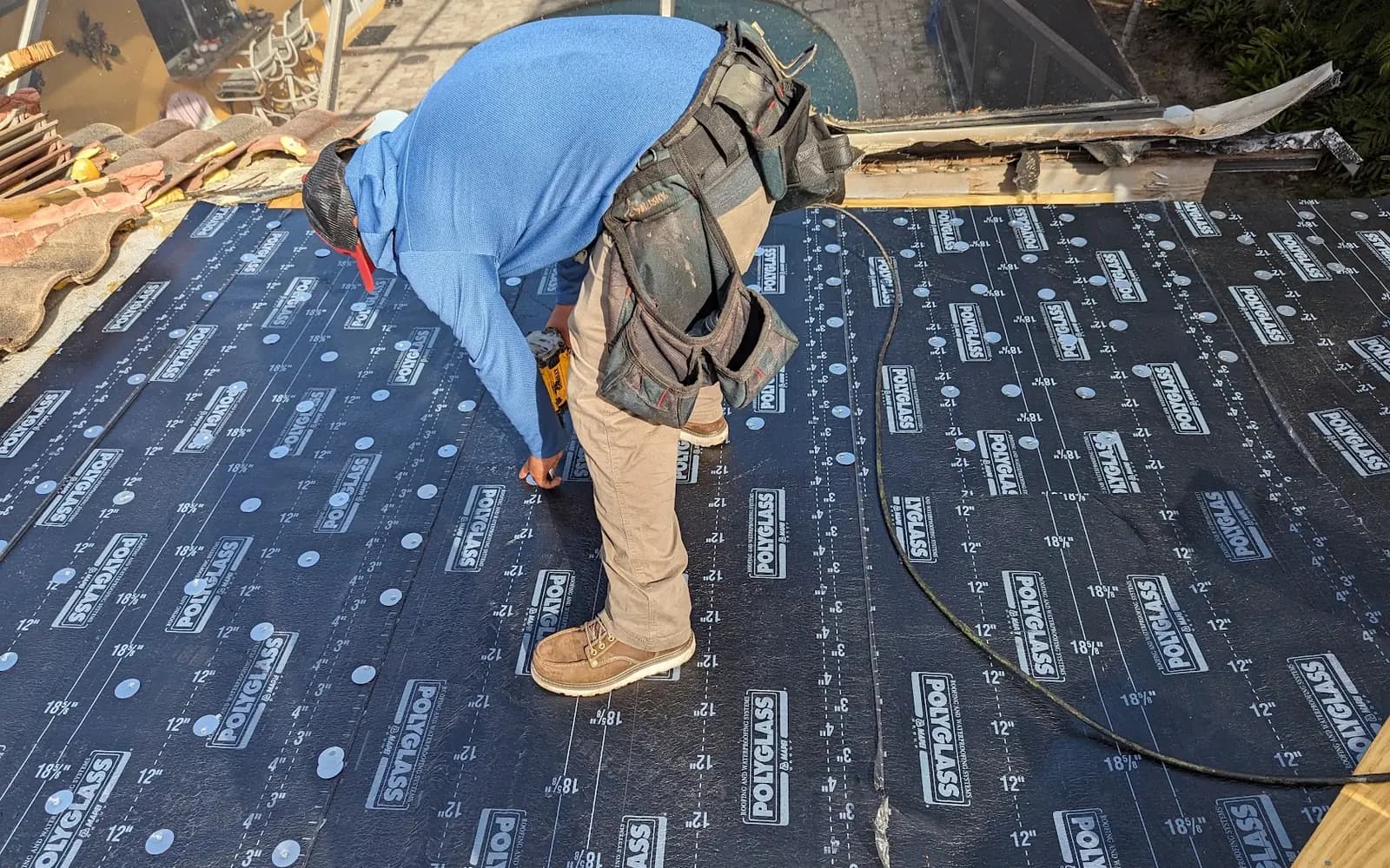 Roofer installing peel-and-stick underlayment